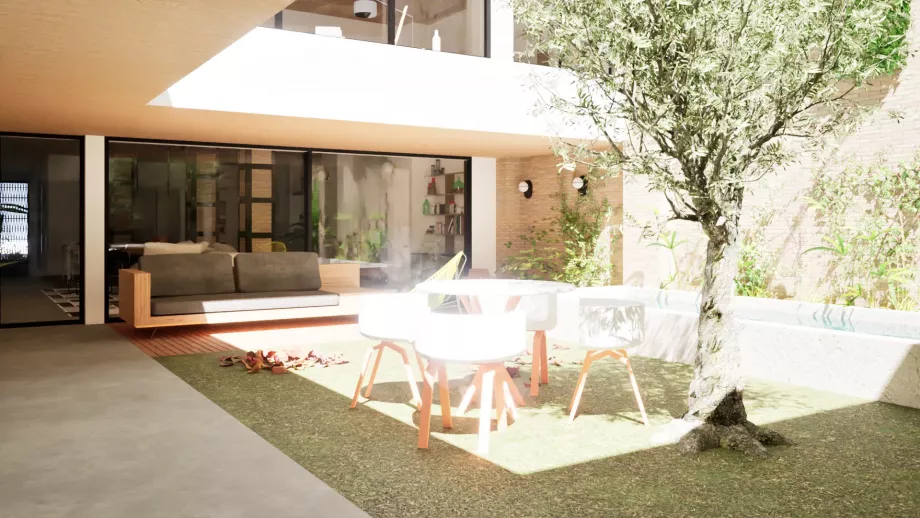 Vista de patio ajardinado central, mesa, árbol y piscina de rehabilitación passivhaus en valencia